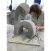 letzter Schliff an der fertigen Betonskulptur